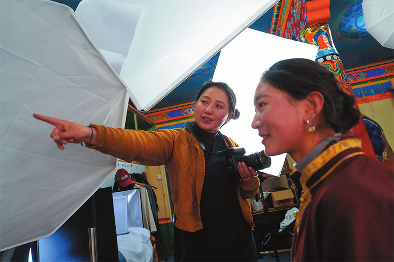 འདི་ནི་ཉེ་དུས“མཁྱེན་ལི་བཟོ་ཁང”གི་པར་རྒྱག་ཁང་དུ་ཟླ་བ་སྒྲོལ་མས（གཡོན）མོ་ཐྲོལ་ལ་སྤུས་རྟགས་ཀྱི་རྣ་རྒྱན་བཏགས་ནས་པར་ཇི་ལྟར་རྒྱག་དགོས་མིན་སྐོར་སློབ་བཞིན་པ།