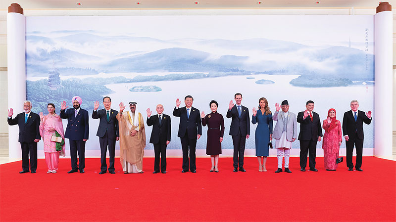 ཟླ་9ཚེས་23ཉིན་གྱི་ཉིན་དགུང་། རྒྱལ་ཁབ་ཀྱི་ཀྲུའུ་ཞི་ཞི་ཅིན་ཕིང་དང་སྐུ་ཟླ་ཕེང་ལི་ཡོན་གྱིས་ཀྲེ་ཅང་ཞིང་ཆེན་ཧང་ཀྲོའུ་གྲོང་ཁྱེར་གྱི་ཤིས་ཙེ་གསོལ་མགྲོན་ཁང་དུ་གསོལ་སྟོན་བཤམས་ནས་ཧང་ཀྲོའུ་ཨེ་ཤེ་ཡའི་ལུས་རྩལ་འགྲན་ཚོགས་སྐབས་19པའི་འགོ་ཚུགས་མཛད་སྒོར་ཞུགས་མཁན་རྒྱལ་སྤྱིའི་སྐུ་མགྲོན་ལ་དགའ་བསུ་ཞུས་ཤིང་། འདི་ནི་ཞི་ཅིན་ཕིང་དང་ཕེང་ལི་ཡོན་གྱིས་སྐུ་མགྲོན་ཚོ་དང་ལྷན་དུ་དྲན་རྟེན་པར་བསྐྱོན་བཞིན་པ།